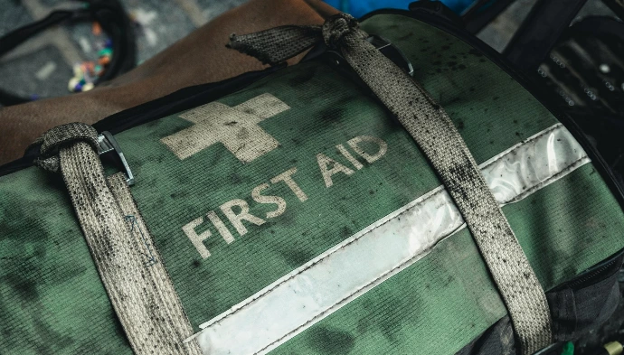 green and black first aid bag